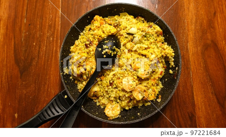 Sardinian fregula, traditional Sardinian pasta, made in a pan with seafood and saffron. 97221684