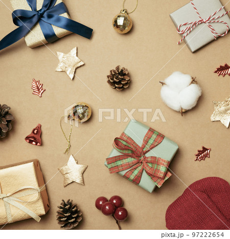 Christmas ornament and gift box on brown background. Christmas winter decoration. flat lay, top view Christmas ornament and gift box on brown background. Christmas winter decoration. flat lay, top view 97222654