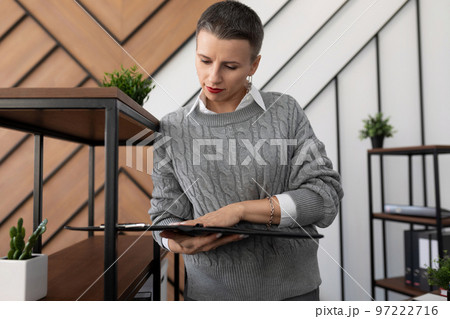 woman specialist stands with papers and documents on the background of the office 97222716