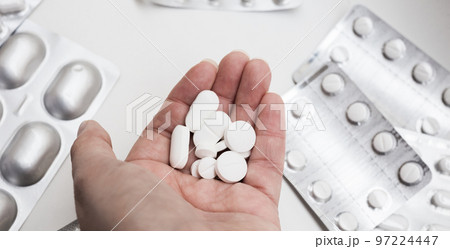 medical tablets in the palm of your hand for the treatment of diseases 97224447
