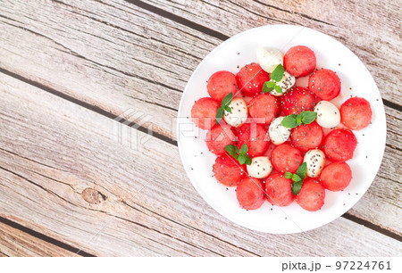 Summer fruit salad with watermelon, mozzarella cheese top view 97224761
