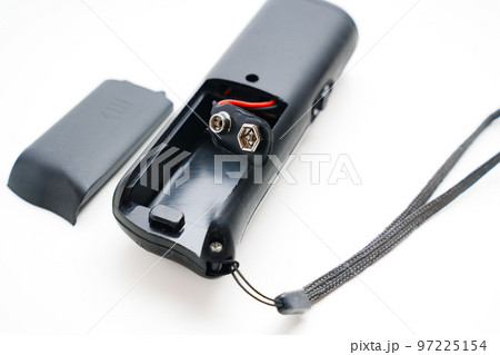 Ultrasonic dog repeller open without batteries on a white background. Ultrasonic dog repeller open without batteries on a white background. 97225154