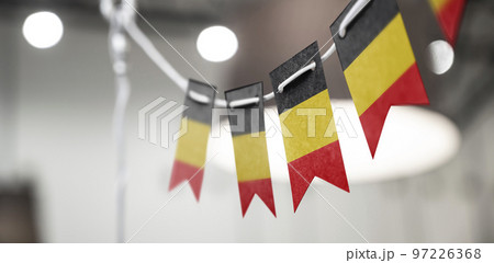 A garland of Belgium national flags on an abstract blurred background A garland of Belgium national flags on an abstract blurred background 97226368