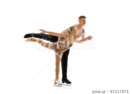 Synchronicity. Portrait of young man and woman, figure skating athletes performing isolated over white studio background Synchronicity. Portrait of young man and woman, figure skating athletes performing isolated over white studio background 97227873