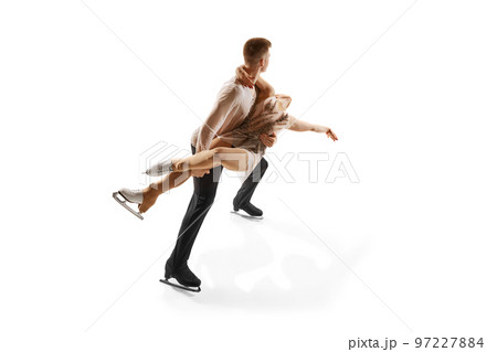 Ice dancing. Portrait of young man and woman, figure skating athletes performing isolated over white studio background Ice dancing. Portrait of young man and woman, figure skating athletes performing isolated over white studio background 97227884