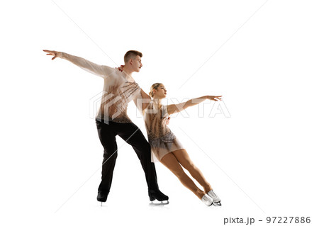 Portrait of young man and woman, figure skating athletes performing isolated over white studio background Portrait of young man and woman, figure skating athletes performing isolated over white studio background 97227886