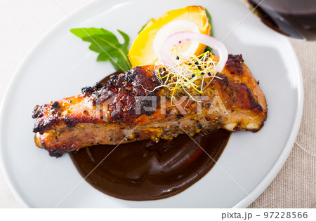 Grilled pork ribs with chocolate sauce and baked potatoes Grilled pork ribs with chocolate sauce and baked potatoes 97228566