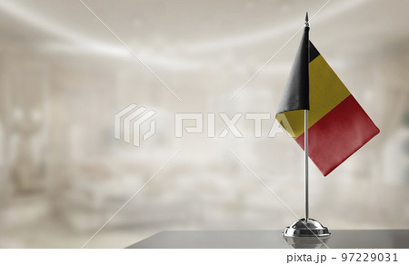 A small Belgium flag on an abstract blurry background 97229031