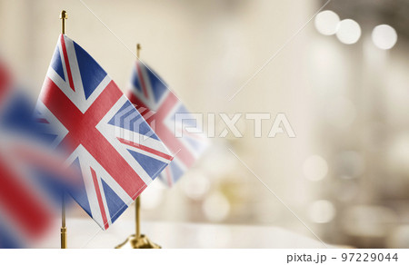 Small flags of the United Kingdom on an abstract blurry background 97229044