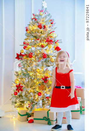 girl with a hat of Santa Claus stands in New Year's decorations 97229841