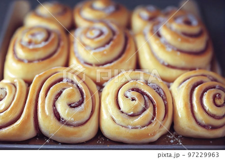 Beautiful lush cinnamon buns with fruit filling 97229963