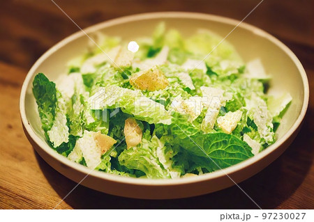 Bowl of green chicken caesar salad with fresh lettuce leaves Bowl of green chicken caesar salad with fresh lettuce leaves 97230027