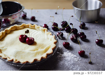 Delicious freshly baked cherry pie decorated with fresh berries Delicious freshly baked cherry pie decorated with fresh berries 97230337
