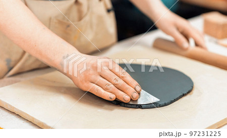 The master of sculpting pottery working in a studio 97231225