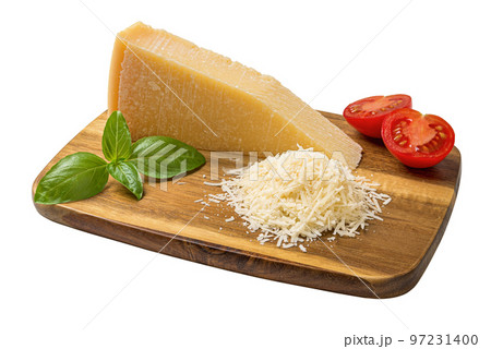 Whole and grated parmesan on a cutting board cutout. 97231400