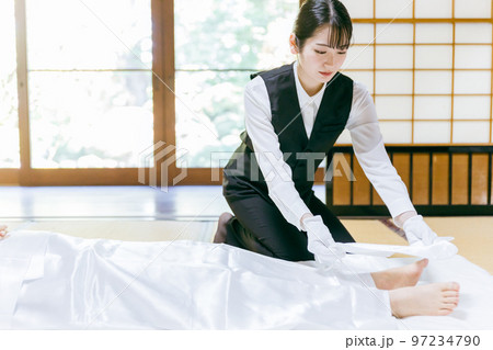 故人の死装束・脚絆をつける湯灌師・納棺師・おくりびと・エンバーマーの日本人女性(エンゼルケア・清拭) 故人の死装束・脚絆をつける湯灌師・納棺師・おくりびと・エンバーマーの日本人女性(エンゼルケア・清拭) 97234790