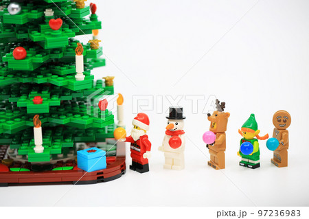 people dressing the Christmas costume and hanging the ornament in the party people dressing the Christmas costume and hanging the ornament in the party 97236983