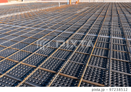 Close up view of reinforcement of concrete. Geometric alignment of Rebars on construction site. Reinforcements steel bars stack. Close up view of reinforcement of concrete. Geometric alignment of Rebars on construction site. Reinforcements steel bars stack. 97238512
