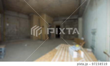 Interior construction of new house project with grey cement wall background. Stairs in empty livings room. Defocused and Blured empty room without furniture for renovation concept Interior construction of new house project with grey cement wall background. Stairs in empty livings room. Defocused and Blured empty room without furniture for renovation concept 97238519