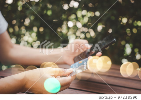 Close up hand of woman using credit card and smartphone during slide screen for finding product purchase buying payments online shopping, making secure internet payment browsing banking service Close up hand of woman using credit card and smartphone during slide screen for finding product purchase buying payments online shopping, making secure internet payment browsing banking service 97238590