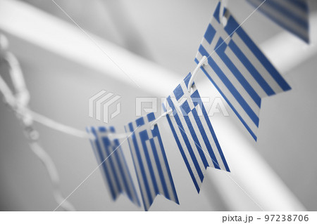 A garland of Greece national flags on an abstract blurred background A garland of Greece national flags on an abstract blurred background 97238706