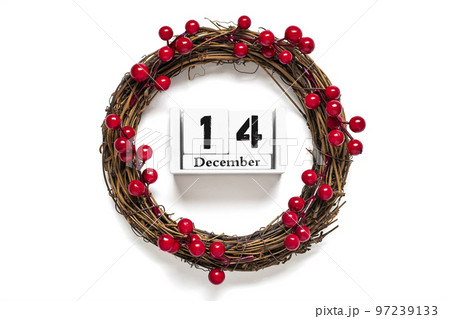 Christmas wreath decorated with red berries, wooden calendar date 12 December isolated on white background Concept of Christmas preparation, atmosphere Wishes card Hand made Christmas wreath Flat lay. 97239133