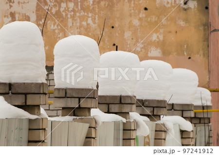 Beautiful, even, high columns of snow on brick pillars. 97241912
