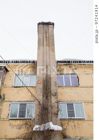 Smoke, stone exhaust pipe along the wall of the old house. 97241914