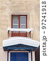 A small balcony covered with snow over a canopy with a large white snowdrift 97241918