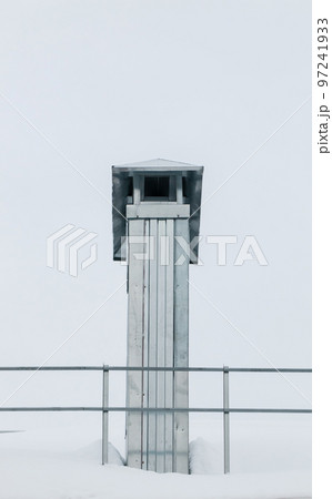 Smoke, rectangular exhaust pipe on the roof of a modern house. 97241933