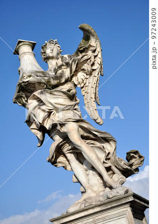 Marble statue of Angel against blue sky Marble statue of Angel against blue sky 97243009