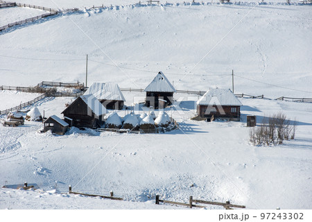 Alpine village in winter in Transylvania 97243302