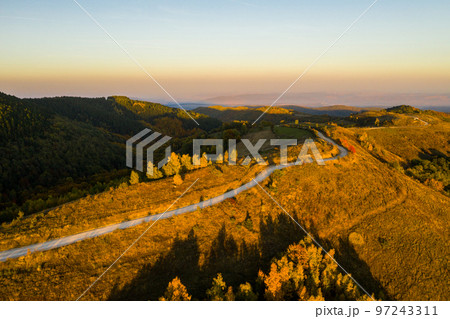 Aerial view of winding road at autumn 97243311