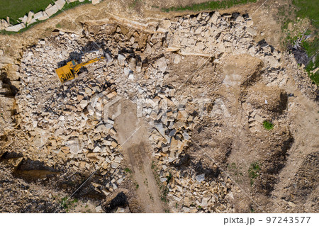 Aerial view of excavator working in a limestone quarry 97243577