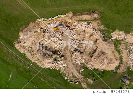 Aerial view of excavator working in a limestone quarry 97243578