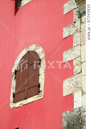 Old window on a red wall 97243810