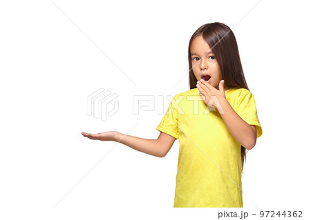 Little girl holds out her hand in surprise 97244362