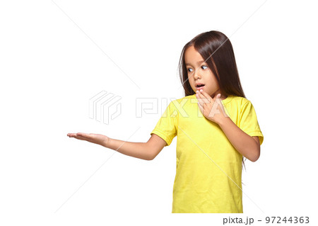 Little girl in yellow t-shirt holding her hand out 97244363