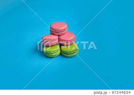 Colored macaron or macaroon, sweet meringue-based confection on blue background. Close-up, copy space. 97244634
