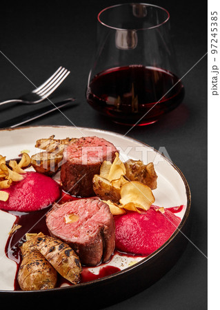 Roasted veal meat with jerusalem artichokes and sauce. Roasted veal meat with jerusalem artichokes and sauce. 97245385