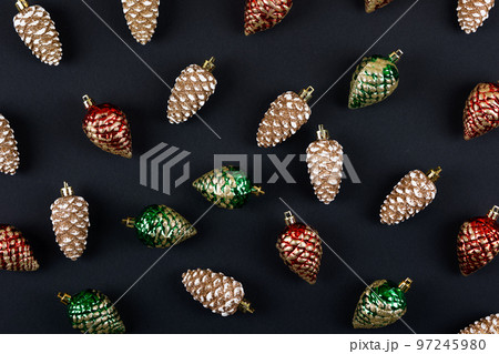 Abstract background of their Christmas decorations in the form of red green and gold pine cones 97245980
