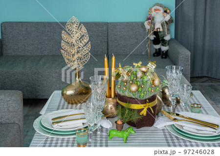 New Year's festive table setting, cutlery, decorations, New Year's decor, Christmas serving New Year's festive table setting, cutlery, decorations, New Year's decor, Christmas serving 97246028