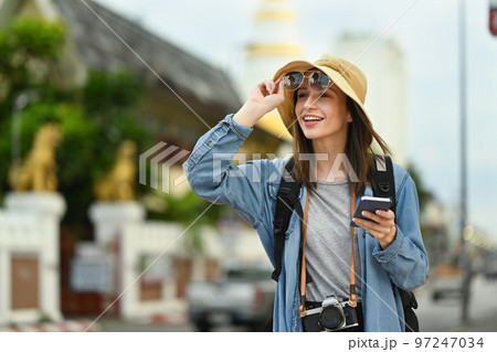 Beautiful caucasian woman traveler with backpack on holiday vacation trip in Thailand. Lifestyle travel and technology concept 97247034