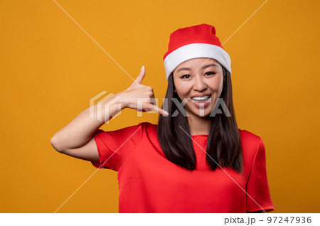 Cute happy young woman in red speaking on air phone 97247936
