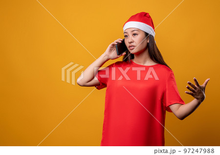 Young woman in red speaking on the phone 97247988