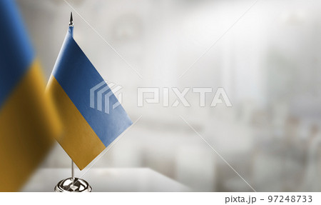 Small flags of the Ukraine on an abstract blurry background 97248733