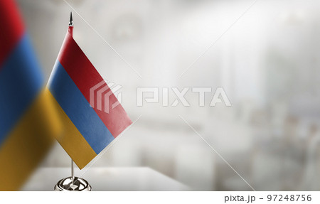 Small flags of the Armenia on an abstract blurry background Small flags of the Armenia on an abstract blurry background 97248756