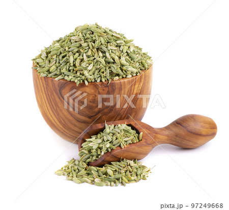 Fennel seeds in wooden bowl and spoon, isolated on white background. Green fennel grains. Spices and herbs. 97249668