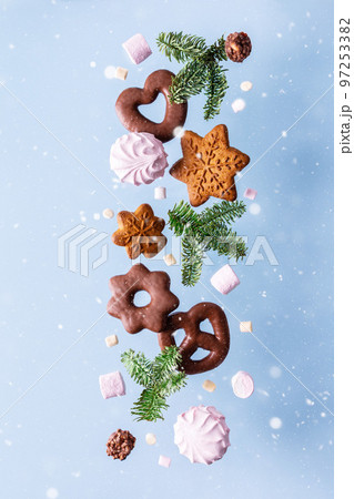 Levitation of sweets on a blue background Levitation of sweets on a blue background 97253382