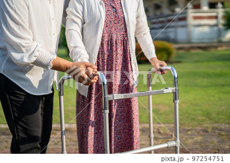 Help and care Asian senior or elderly old lady woman use walker with strong health while walking at park in happy fresh holiday. Help and care Asian senior or elderly old lady woman use walker with strong health while walking at park in happy fresh holiday. 97254751